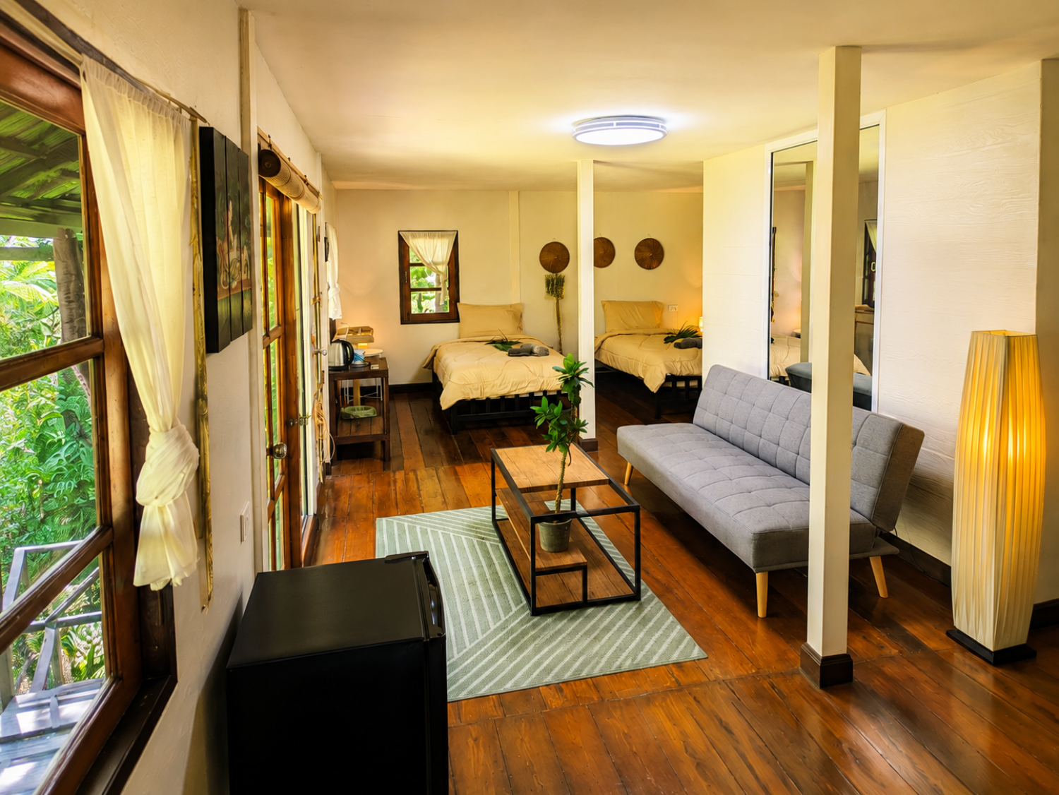 Living room of a Jungle Villa with sofa and panoramic garden window